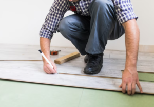 trades person marking placed floor tiles