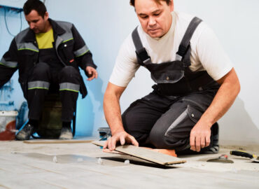 installing ceramic floor tiles construction site construction workers workers laying tiles floor with cement adhesive renovating floor