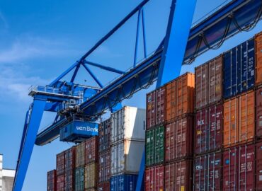 overhead crane working next to dock on shipping cranes