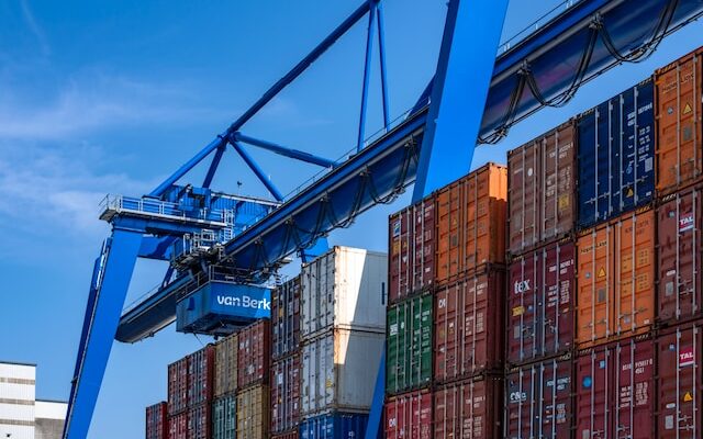 overhead crane working next to dock on shipping cranes