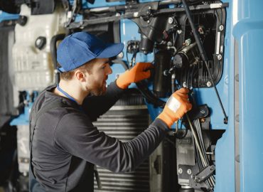 Atlas copco compressor being looked at by a tradesperson