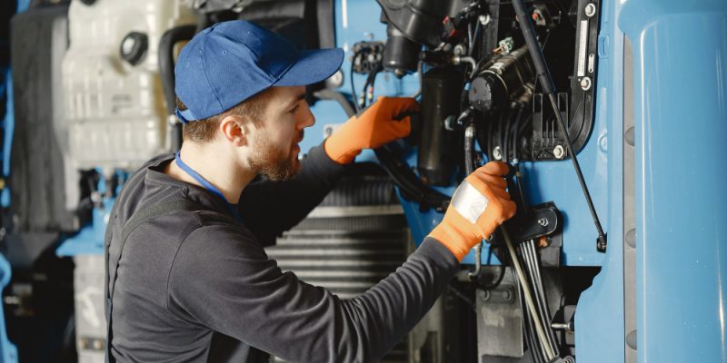 Atlas copco compressor being looked at by a tradesperson